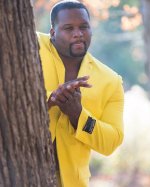 anthony-adams-in-yellow-suit-rubbing-hands.jpg
