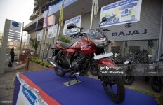 a-motorcycle-sits-on-a-promotional-display-at-a-bajaj-auto-l[1].jpg